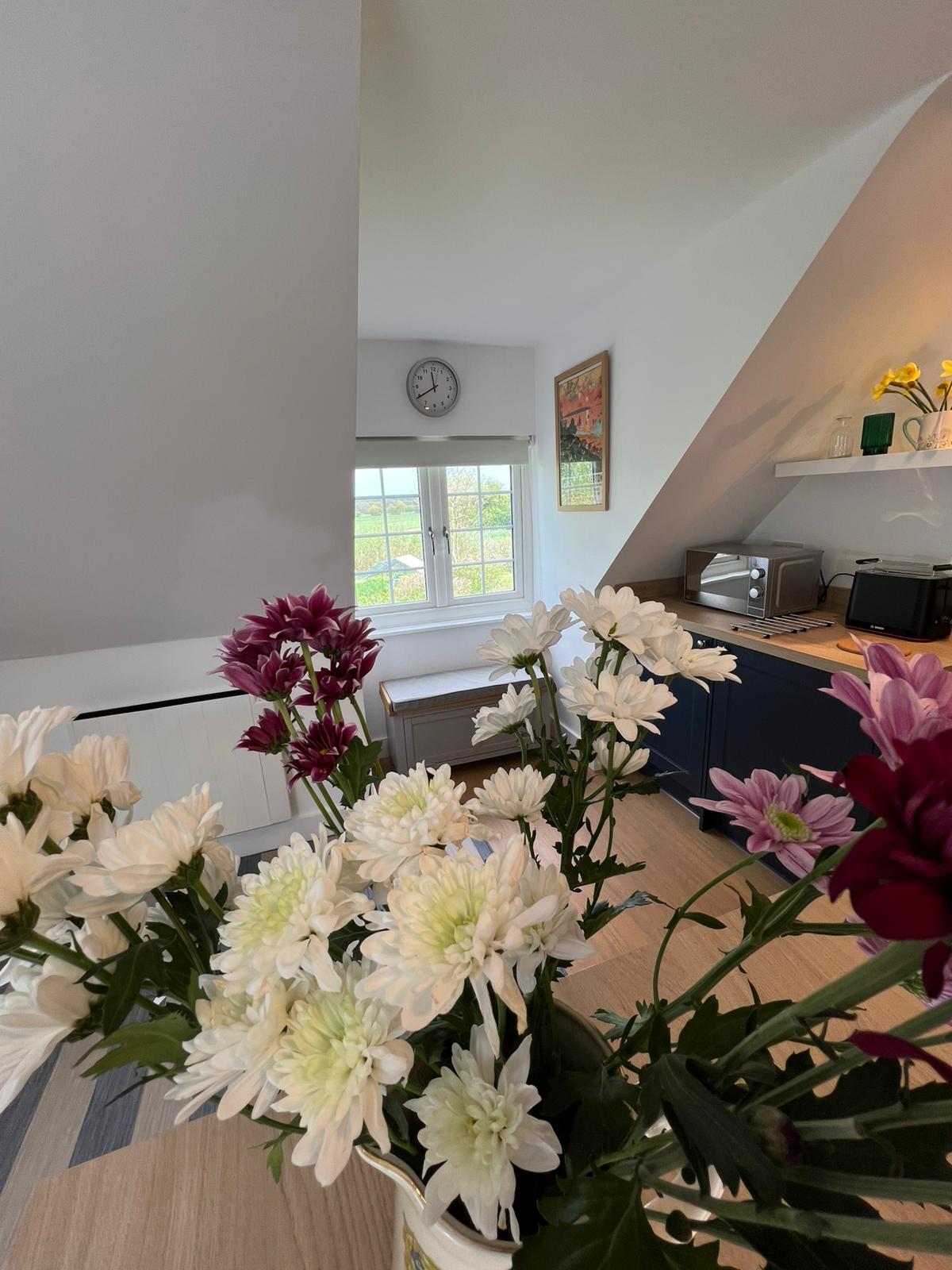 Flowers with farmland view through the window