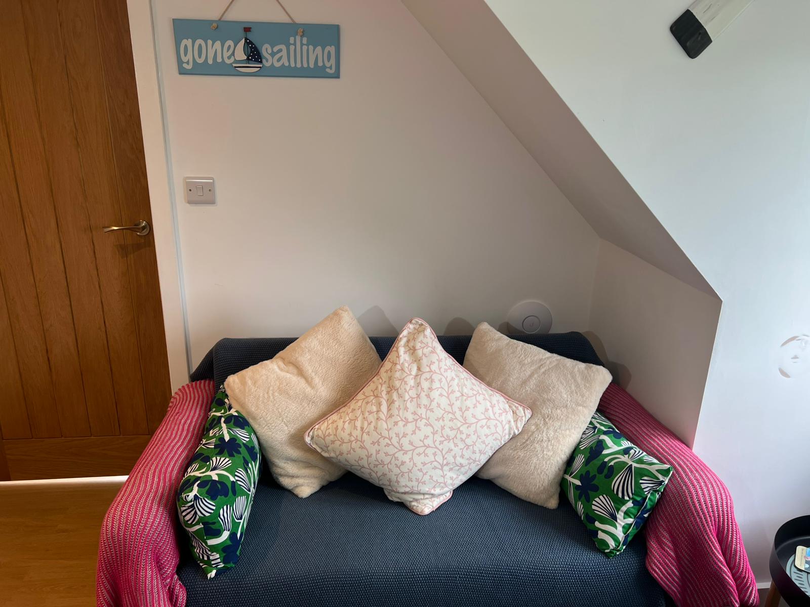 Cosy lounge with gone sailing sign at The Den at the Damsons